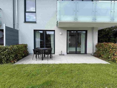 a patio with a table and chairs in front of a house at Mira Premium Residences - Hinterzarten in Hinterzarten