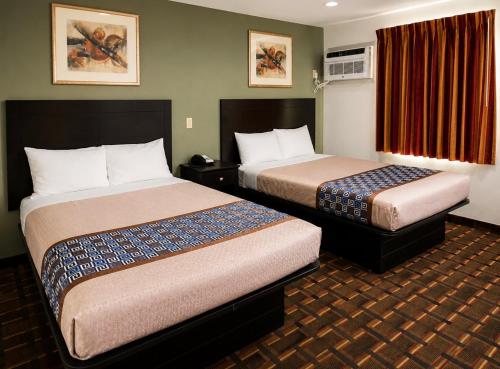 a hotel room with two beds in a room at Budget Inn Ada in Ada