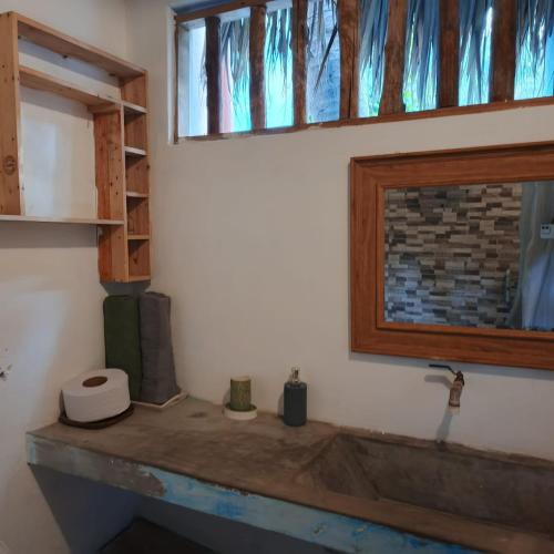 a bathroom with a sink and a window at El Puente in El Paredón Buena Vista