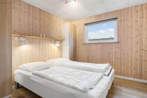 a bed in a room with a window at 8876-Glesborg-Strandvejen-43 in Fjellerup Strand
