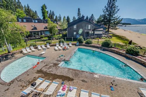 an overhead view of a swimming pool with chairs and a house at Beautiful Condo with private beach access & shared pools in South Lake Tahoe