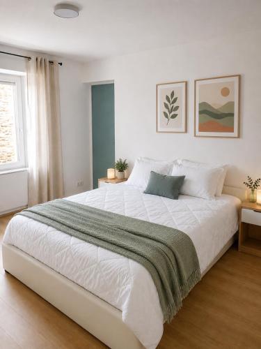 a large white bed in a room with a window at Résidence d'Emilie in Luxeuil-les-Bains