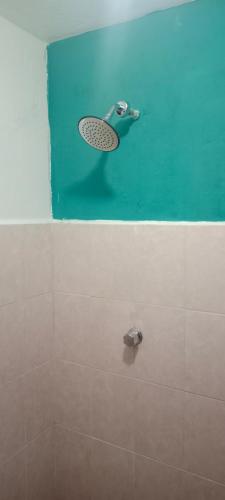 a bathroom with a shower with a racket on the wall at Pilatos in Ocosingo