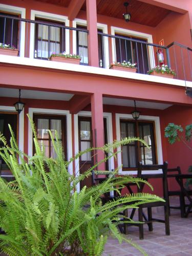 a building with tables and chairs in front of it at Hotel Rivera in Colonia del Sacramento