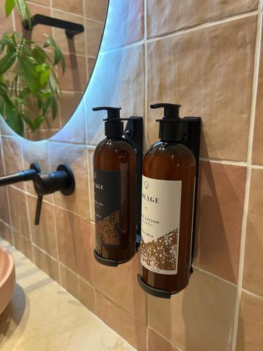 two bottles of coffee on a wall in a bathroom at Sol del Este Luxury by SH in San Andrés