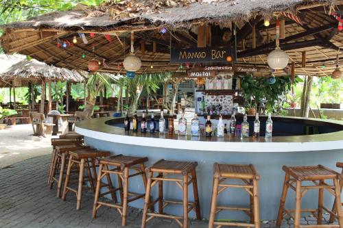 a bar in a resort with stools around it at Cousin Resort Koh Kho Khao Beach in Ko Kho Khao