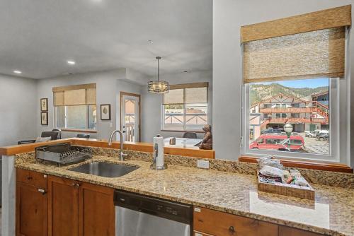 a kitchen with a sink and a large window at Obertal Inn in Leavenworth