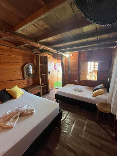 a bedroom with two beds in a wooden house at Chiki luki in Playa Blanca