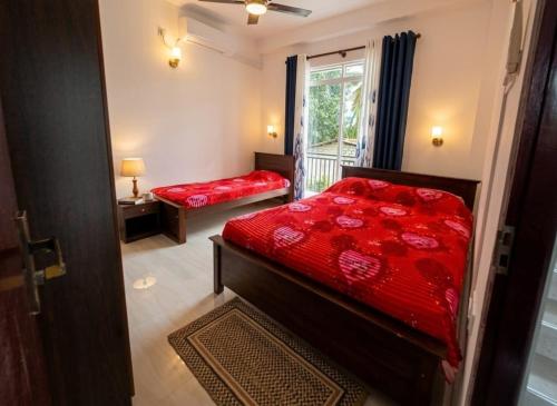 a bedroom with two beds and a window at MSM Diamond Villa in Wattala