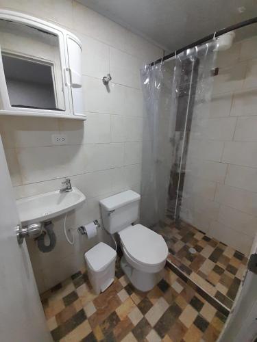 a bathroom with a toilet and a sink and a shower at Central Apartment Salento Colombia in Salento