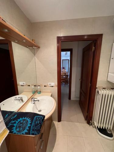 a bathroom with a sink and a mirror and a radiator at Mas d'Arturo in Serós