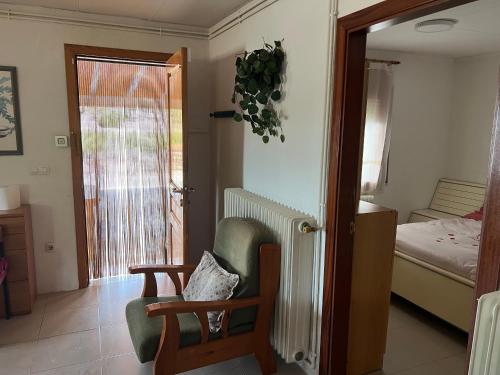 a living room with a chair and a bedroom at Mas d'Arturo in Serós