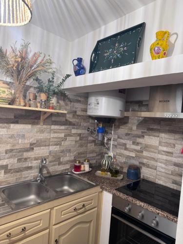 a kitchen with a sink and a counter top at Casa das Portas de Évora in Estremoz