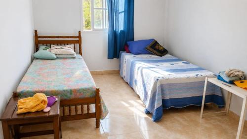 a small bedroom with two beds and a table at Depto rep del libano 11 capacidad 5 personas in La Banda
