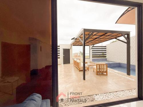a view of a living room from a glass window at Beachfront pool whirlpool & firepit in Montañita