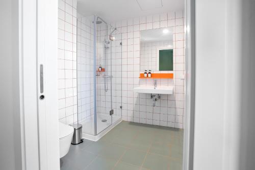 a bathroom with a toilet and a sink and a shower at Boavista 83 Hostel Lisbon in Lisbon