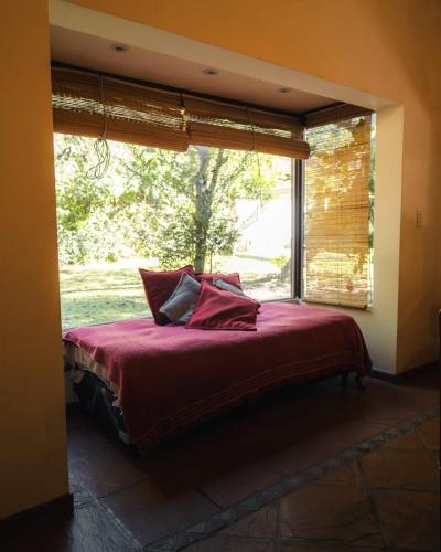 a bed in a room with a large window at Canto a Jujuy - Yala in Yala