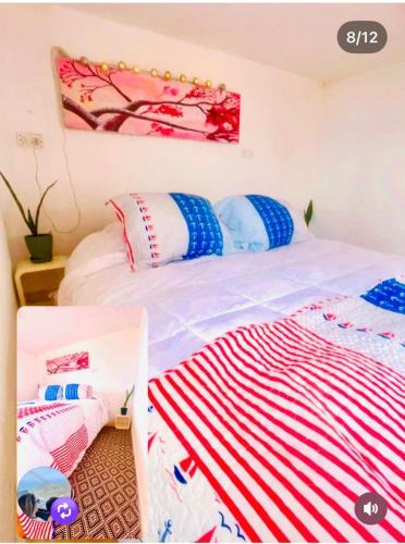 a bedroom with two beds and a painting on the wall at The whale in Guaquen