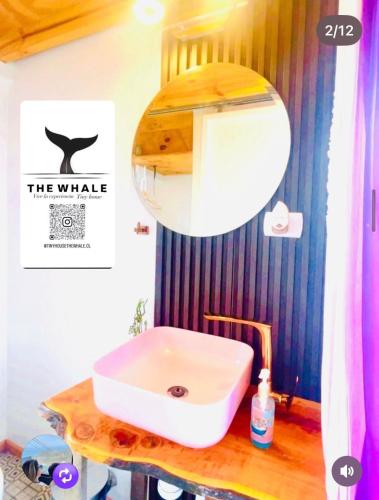 a white sink on a wooden counter in a bathroom at The whale in Guaquen