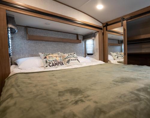 a large bed in the middle of a room at Ouachita Outpost RV Park in Hodgen