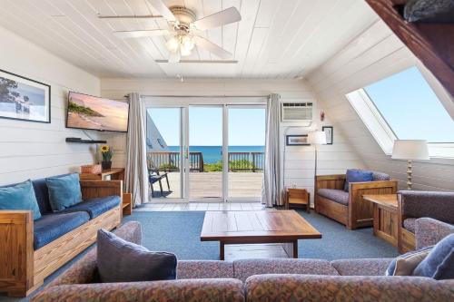 a living room with couches and a table at Chalet #20 in Stevensville