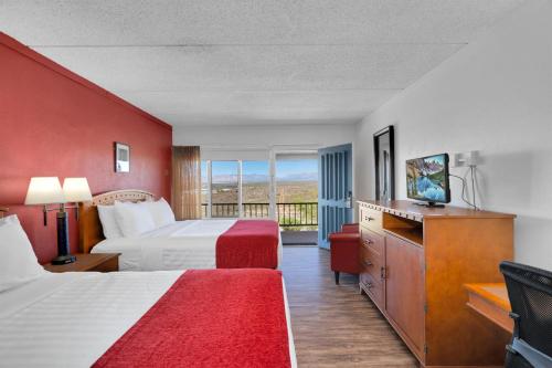a hotel room with two beds and a balcony at Tombstone Lookout Lodge, SureStay Collection by Best Western in Tombstone
