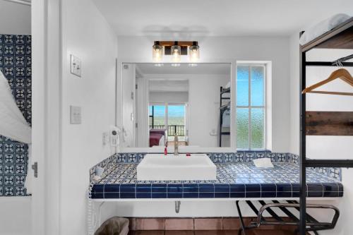a bathroom with a large mirror and a tub at Tombstone Lookout Lodge, SureStay Collection by Best Western in Tombstone