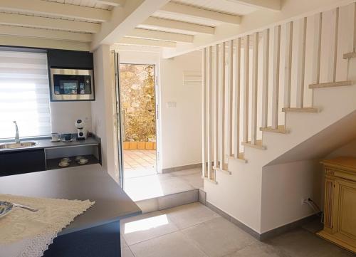 a kitchen with a staircase in a house at Aldea de Rosalía in Padrón