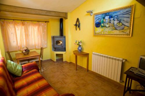 a living room with a couch and a stove at El Rincón de Monasterio in Monasterio