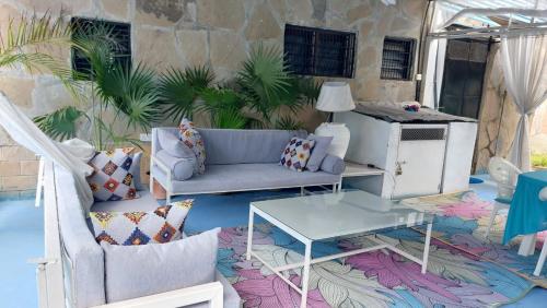 a living room with a couch and a table at Nyali Garden Escape Villa in Mombasa
