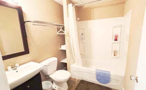 a small bathroom with a toilet and a sink at Wakaw Inn in Wakaw