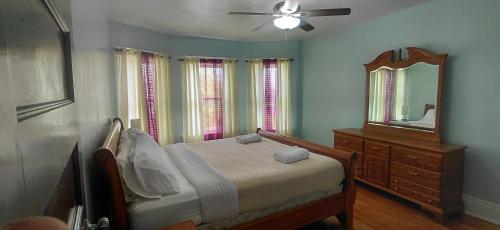 a bedroom with a bed and a mirror and a dresser at Eagle's Hub Niagara ny in Niagara Falls