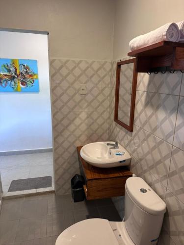 a bathroom with a toilet and a sink at Toba Crest Vue in Parapat