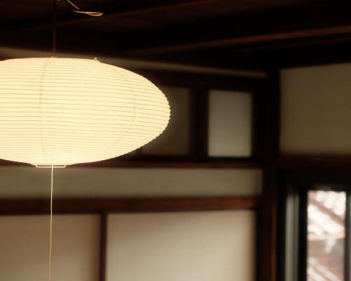a white paper lantern hanging from a ceiling at Omoya Kitahata in Karatsu