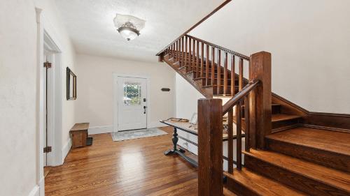 a hallway with a wooden staircase in a house at Brevard Bliss in Brevard