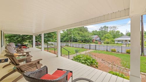 a porch with chairs and a view of a yard at Brevard Bliss in Brevard
