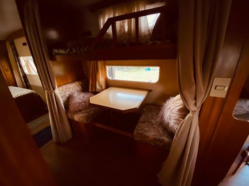 a small room with two chairs and a table and a window at Tiny house móvel com vista 360 in São Roque