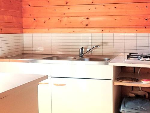 a kitchen with white cabinets and a sink at Chalet - Animaux admis - 4 pers. - API-1-52-2942 in Annot
