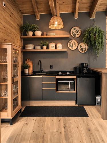 a kitchen with a sink and a stove at cabana Eco da Natureza in Praia Grande
