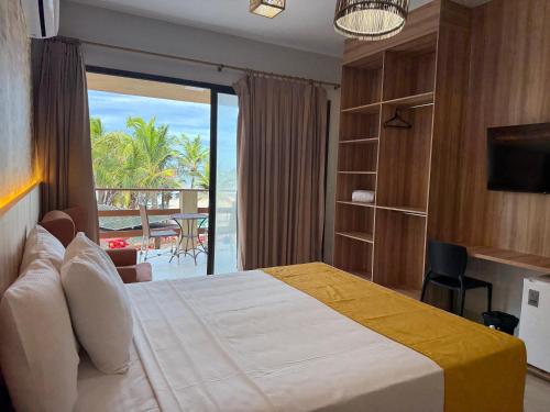 a bedroom with a bed with a view of the ocean at G2 Beach Hotel in Aquiraz