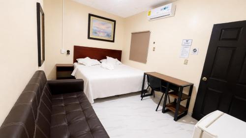 a hotel room with a bed and a couch at Hotel King del Centro San Miguel in San Miguel