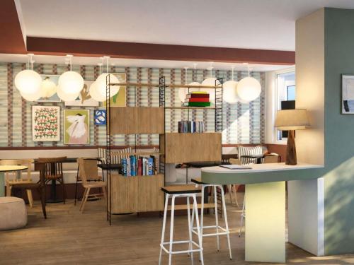 a living room with a bar and some chairs at Greet Lourdes Centre Pyrenees in Lourdes