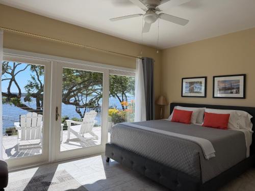 a bedroom with a bed and a sliding glass door at Waterway in Charleston