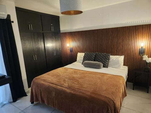 a bedroom with a large bed with two pillows on it at Modern Apartment in Rosarito