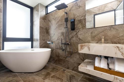 a bathroom with a tub and a sink at ZJ Villa in Sanxing