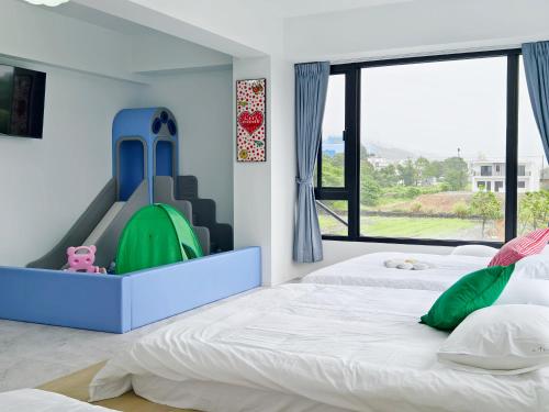 a bedroom with two beds and a large window at ZJ Villa in Sanxing
