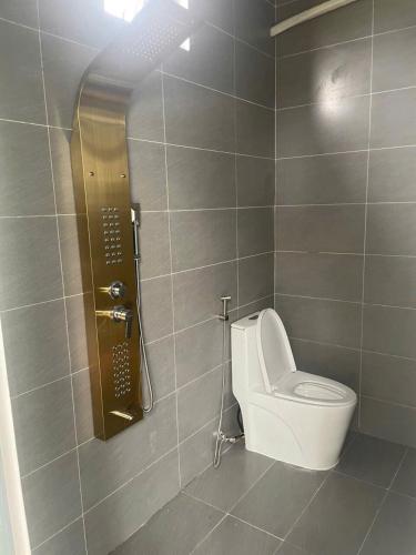 a bathroom with a toilet and a shower in a stall at homestay windhills in Ấp Nhơn Hòa