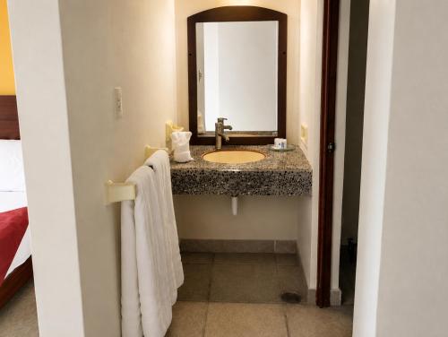 a bathroom with a sink and a mirror at Hotel Tepoztlán in Tepoztlán
