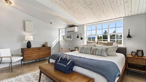 a bedroom with a large bed and a large window at Cascade Crest by AvantStay in Bend