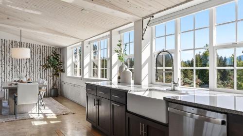a kitchen with a large sink and windows at Cascade Crest by AvantStay in Bend